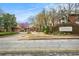 Community entrance with stone signage, manicured landscaping, and a gated entry at 708 Mcgill Ne Pl, Atlanta, GA 30312