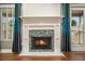 Close-up of a fireplace with a decorative tile surround, white mantle, and ambient lighting at 708 Mcgill Ne Pl, Atlanta, GA 30312
