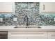 Kitchen sink with tile backsplash and light countertop at 708 Mcgill Ne Pl, Atlanta, GA 30312