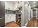 Kitchen area with wine cooler, stainless steel refrigerator, and backsplash with white cabinetry at 708 Mcgill Ne Pl, Atlanta, GA 30312