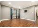 Open concept living room, filled with natural light, features a TV mount and wood floors at 708 Mcgill Ne Pl, Atlanta, GA 30312