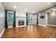 Bright living room featuring a fireplace, hardwood floors, and access to a balcony at 708 Mcgill Ne Pl, Atlanta, GA 30312