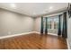Spacious living room featuring large windows with curtains and hardwood floors at 708 Mcgill Ne Pl, Atlanta, GA 30312