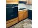 Well-equipped kitchen featuring black appliances and ample wood cabinetry at 2414 West Rd, Riverdale, GA 30296