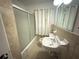 Bathroom featuring a vanity sink and tiled shower-tub combo at 2414 West Rd, Riverdale, GA 30296