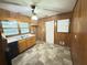 Kitchen with wood paneling, laminate flooring, and ample counter space at 2414 West Rd, Riverdale, GA 30296