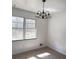 Bright living room featuring large windows and a traditional chandelier at 2414 West Rd, Riverdale, GA 30296