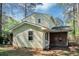 Backyard featuring the house exterior with siding, brick foundation, and lawn at 3052 Sw Highbury Sw Trl, Atlanta, GA 30354
