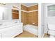 Bright bathroom featuring double sinks and tile tub with tile walls at 3052 Sw Highbury Sw Trl, Atlanta, GA 30354