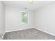 Neutrally decorated bedroom featuring gray carpet and a window view at 3052 Sw Highbury Sw Trl, Atlanta, GA 30354