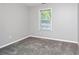 Neutral bedroom with a window and soft gray carpet at 3052 Sw Highbury Sw Trl, Atlanta, GA 30354