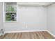 Walk-in closet featuring wood-look floors, a window, and a built-in closet organizer at 3052 Sw Highbury Sw Trl, Atlanta, GA 30354