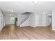 Spacious living room with wood-look floors, fresh paint, natural light, and staircase to the second floor at 3052 Sw Highbury Sw Trl, Atlanta, GA 30354