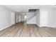 Spacious living room with wood-look floors, fresh paint, natural light, and staircase to the second floor at 3052 Sw Highbury Sw Trl, Atlanta, GA 30354