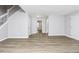 Spacious living room with wood-look floors, fresh paint, natural light, and staircase to the second floor at 3052 Sw Highbury Sw Trl, Atlanta, GA 30354