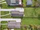Aerial view of a grassy backyard, neighboring homes, and lengthy driveways on a bright, sunny day at 3117 Dogwood Dr, Hapeville, GA 30354