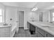 Bright bathroom featuring updated double vanity with grey cabinets and a combined tub and shower at 3117 Dogwood Dr, Hapeville, GA 30354