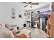 Bedroom with carpet, a window, a ceiling fan, and a cozy lounge area featuring an oversized ottoman at 3117 Dogwood Dr, Hapeville, GA 30354