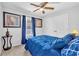 This bedroom features carpet, a window, a ceiling fan, and a comfy bed with navy blue bedding at 3117 Dogwood Dr, Hapeville, GA 30354