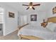 Bright bedroom featuring neutral walls, carpet, and a ceiling fan above an inviting queen-sized bed at 3117 Dogwood Dr, Hapeville, GA 30354