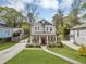 Charming two-story home featuring a welcoming front porch and well-manicured lawn with beautiful landscaping at 3117 Dogwood Dr, Hapeville, GA 30354
