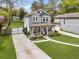 Beautifully landscaped front yard with a charming two-story home and private driveway at 3117 Dogwood Dr, Hapeville, GA 30354