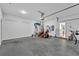 Spacious garage includes a lawnmower, bicycle, and an overhead door for easy access at 3117 Dogwood Dr, Hapeville, GA 30354
