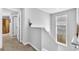 Hallway featuring neutral walls, neutral carpet, white trim, a window, and a glimpse of a wardrobe at 3117 Dogwood Dr, Hapeville, GA 30354