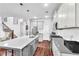 Modern kitchen has an island with seating, stainless appliances, and sleek gray countertops at 3117 Dogwood Dr, Hapeville, GA 30354