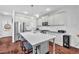 Gourmet kitchen features stainless steel appliances, a center island with seating, and modern light fixtures at 3117 Dogwood Dr, Hapeville, GA 30354