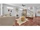 Living room with hardwood floors, fireplace, ottoman with throw, and stairway to the right at 3117 Dogwood Dr, Hapeville, GA 30354