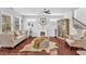Bright living room boasts hardwood floors, a decorative fireplace and comfortable seating near the staircase at 3117 Dogwood Dr, Hapeville, GA 30354
