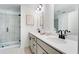 A bathroom features a double vanity, framed mirror and a glass shower enclosure at 93 Wilder Ridge Way, Lawrenceville, GA 30044