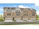 Beautiful townhome showcasing a brick facade, multiple windows, and individual garages for each unit at 93 Wilder Ridge Way, Lawrenceville, GA 30044