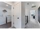 Hallway leading to laundry room with modern washer and dryer units at 93 Wilder Ridge Way, Lawrenceville, GA 30044