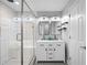Modern bathroom featuring double sinks, marble countertops, and a glass-enclosed shower with white tile at 1251 Pierce Se Ave, Smyrna, GA 30080