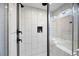 Modern walk-in shower boasts white subway tile and black accents, complete with a built-in niche at 1251 Pierce Se Ave, Smyrna, GA 30080