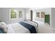 Bright bedroom featuring black bed frame, large windows, walk in closet and green side table at 1251 Pierce Se Ave, Smyrna, GA 30080