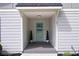 Inviting front entrance with a stylish light blue door, manicured greenery, and a covered porch area at 1251 Pierce Se Ave, Smyrna, GA 30080