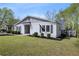 Charming home featuring a well-manicured lawn, lush landscaping, and a side deck perfect for enjoying the outdoors at 1251 Pierce Se Ave, Smyrna, GA 30080