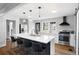 A modern kitchen featuring a large island with seating, stainless steel appliances, and stylish pendant lighting at 1251 Pierce Se Ave, Smyrna, GA 30080
