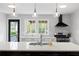 Well-lit kitchen featuring a center island, modern backsplash, stainless steel appliances, and exterior access at 1251 Pierce Se Ave, Smyrna, GA 30080