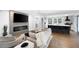 Bright, open-concept living room boasts a modern fireplace, large TV, and seamless flow to the kitchen and breakfast bar at 1251 Pierce Se Ave, Smyrna, GA 30080