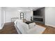 Modern living room boasts a fireplace, TV, light walls, hardwood floors, and modern furniture at 1251 Pierce Se Ave, Smyrna, GA 30080