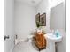 Bathroom featuring neutral tones, a modern pedestal sink, toilet, and a rustic wood vanity at 300 Oldvine Dr, Lawrenceville, GA 30044