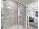 Modern bathroom with glass-enclosed shower and views into main bedroom at 300 Oldvine Dr, Lawrenceville, GA 30044