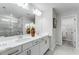 Bathroom featuring dual vanity with white countertops, modern fixtures, and a separate glass-enclosed shower at 300 Oldvine Dr, Lawrenceville, GA 30044