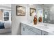 Bright bathroom featuring dual vanity with white countertops, modern fixtures, and a separate glass-enclosed shower at 300 Oldvine Dr, Lawrenceville, GA 30044