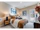 Bedroom featuring neutral tones, a queen-sized bed, side table with lamp, wall art and a glass paneled door at 300 Oldvine Dr, Lawrenceville, GA 30044