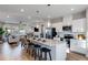 Open-concept kitchen with granite island and breakfast bar overlooks the cozy living area at 300 Oldvine Dr, Lawrenceville, GA 30044